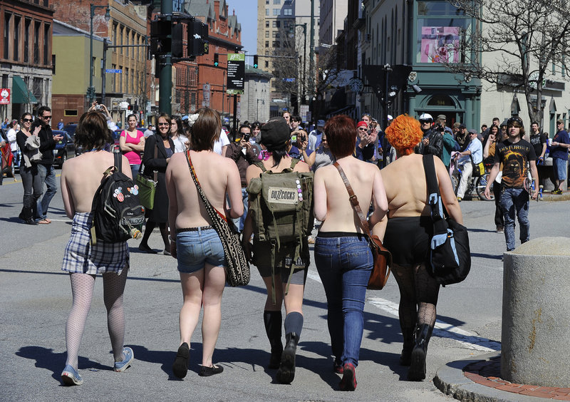 The lead five women in a group that marched topless from Longfellow Square to Tommy’s Park on Saturday cross at the corner of Free and Congress streets in Portland.