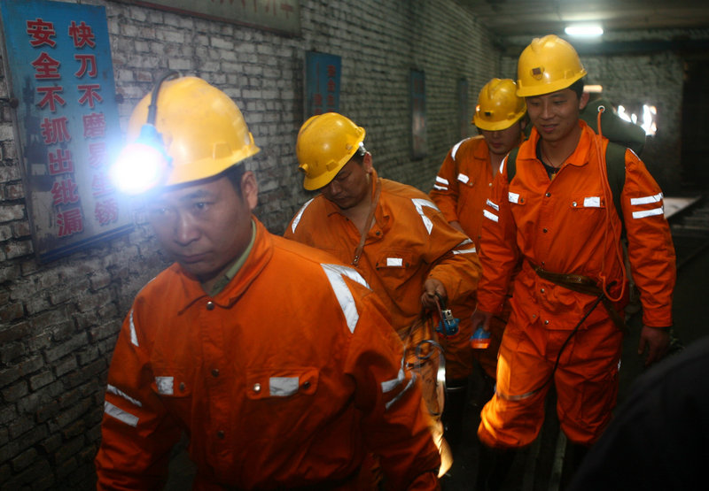 A rescue team enters Wangjialing coal mine to search for survivors in Xiangning, China, on Saturday.