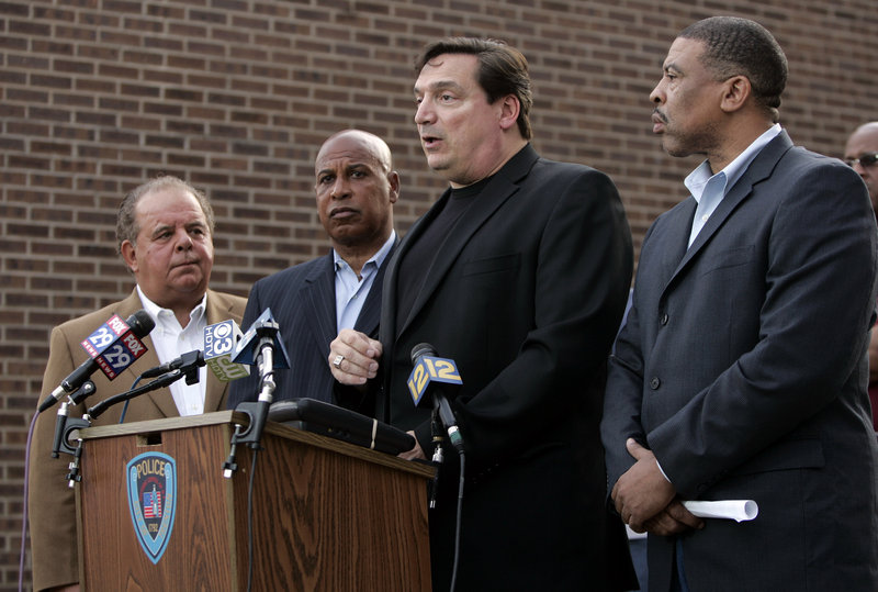 Trenton, N.J., Police Capt. Joseph Jurniak, second from right, with Mercer County Prosecutor Joe Bocchini, left, Trenton Mayor Doug Palmer, second from left, and Police Director Irving Bradley, right, on Saturday announce the arrest of five people in the sexual assault of a 7-year-old girl.