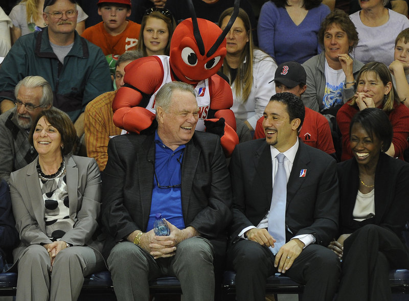 Tommy Heinsohn, the former Boston Celtics great, gets a rubdown from Red Claws mascot Crusher while sitting with D-League President Dan Reed during fan appreciation night at the Expo.