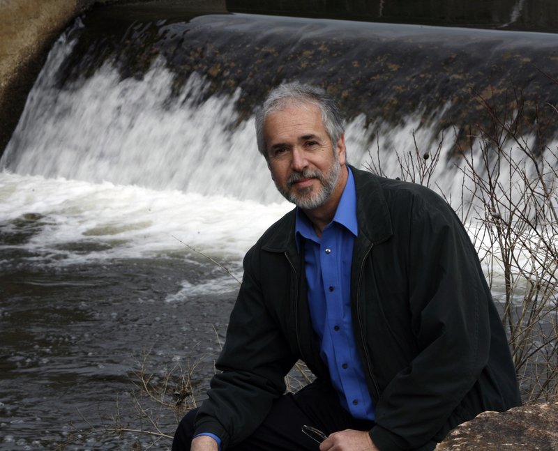 Norm Labbe, water district superintendent, sits by Branch Brook, a water source in Kennebunk. Many utilities are raising rates because water use is down – but, readers say, that's no reason to consider selling any of it.