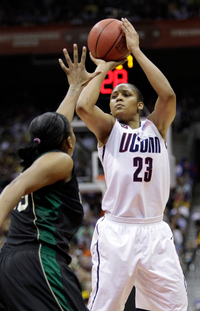 Maya Moore shoots over Morghan Medlock during Connecticut’s 70-50 win over Baylor. Moore finished with 34 points and 12 rebounds.