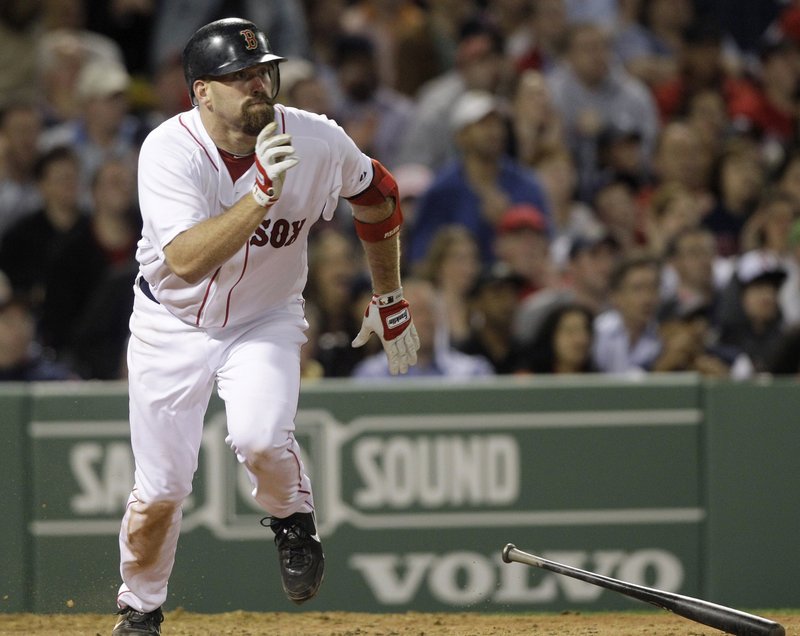 Kevin Youkilis takes a look at the ball while heading to first base on his way to a two-run triple in the sixth inning. Youkilis later scored on Adrian Beltre’s single.