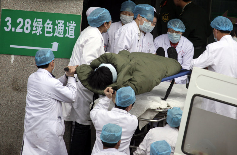 A coal miner rescued from the Wangjialing mine is rushed to a hospital in Hejing town in north China’s Shanxi province Monday. More than 100 Chinese miners were pulled out alive after being trapped for more than a week in a flooded coal mine, sparking cheers among the hundreds of rescue workers who had raced to save them and almost given up hope.