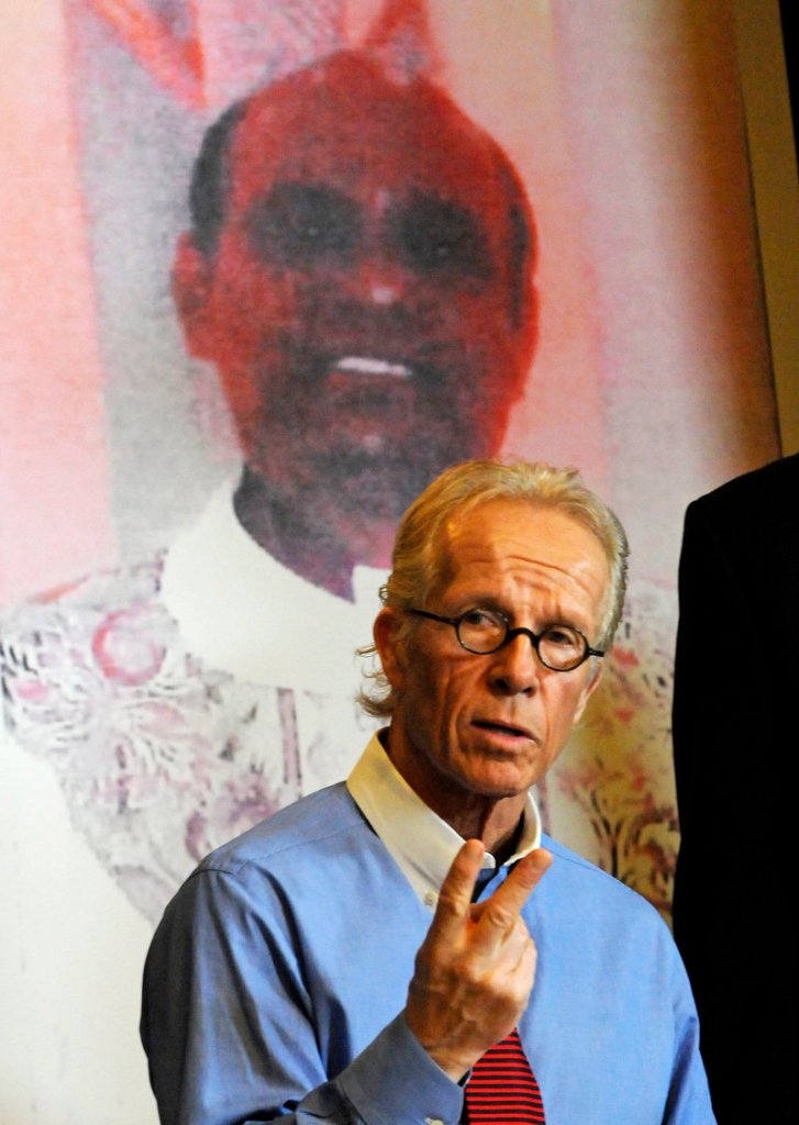 Jeff Anderson, attorney for a girl the Rev. Joseph Palanivel Jeyapaul is accused of sexually assaulting when she was 14, holds a news conference Monday in St. Paul, Minn., in front of a photo of the priest.