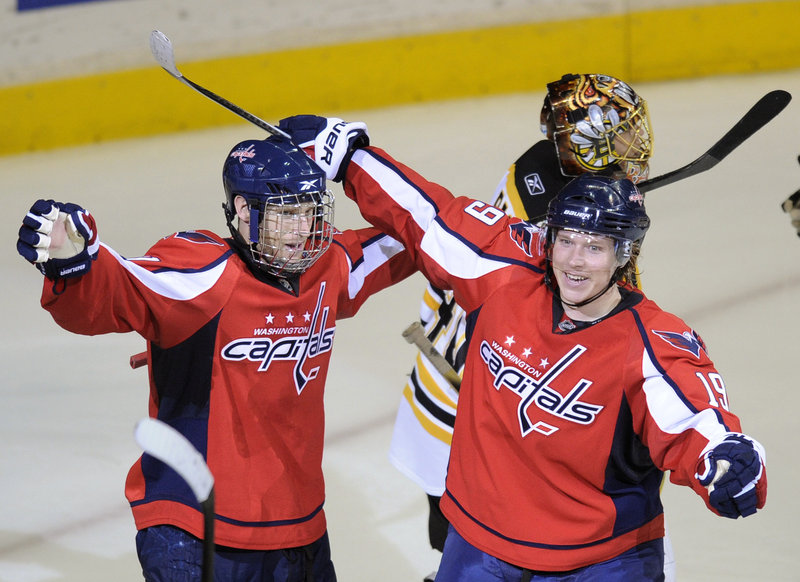 Brooks Laich, left, celebrates with Nicklas Backstrom after scoring a power-play goal in overtime to give the Washington Capitals a 3-2 win Monday over the Boston Bruins.
