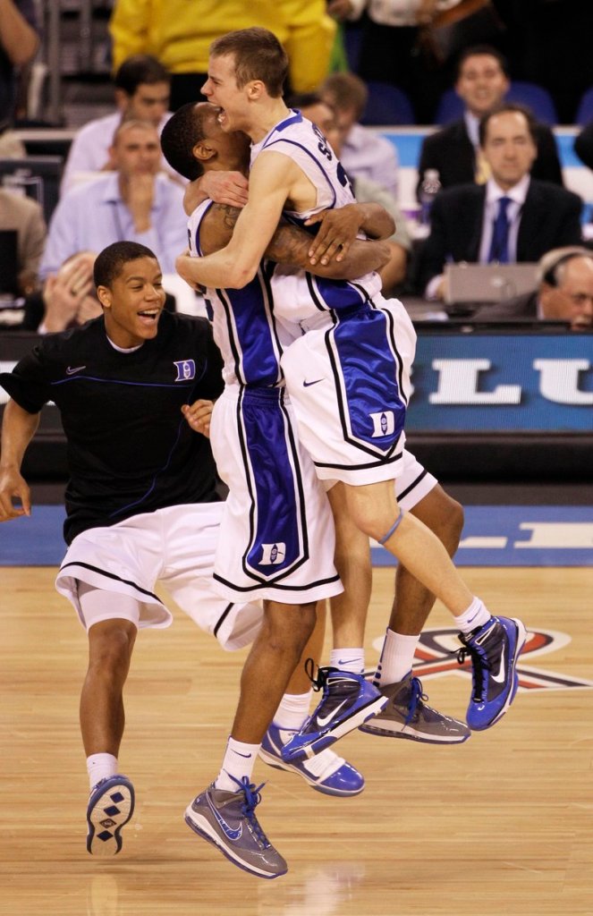 It’s the end of a hard-fought championship game, and Jon Scheyer, right, and Lance Thomas begin Duke’s celebration of its first national title since 2001 after a 61-59 victory Monday night over Butler.