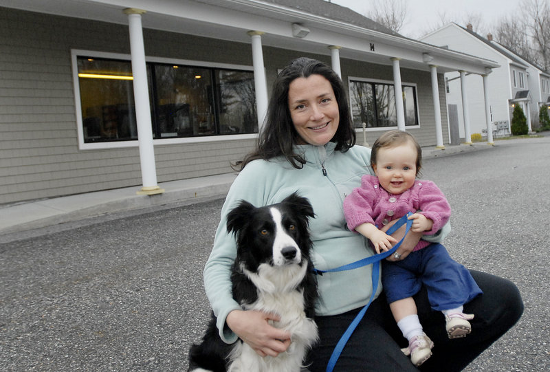 Owner Kristie Green poses outside the new location of Maple's Organics in South Portland, along with her 1-year-old daughter, Violet Milliken, and her border collie, Maple, for whom the business was named.