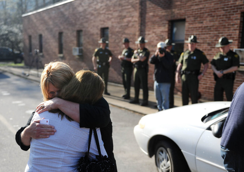 Michelle McKinney hugs Jeannie Sanger, in white, in Whitesville, W.Va.,on Tuesday. Benny Willingham, Sanger’s brother and McKinney’s father, died in a blast at Massey Energy’s Upper Big Branch mine.