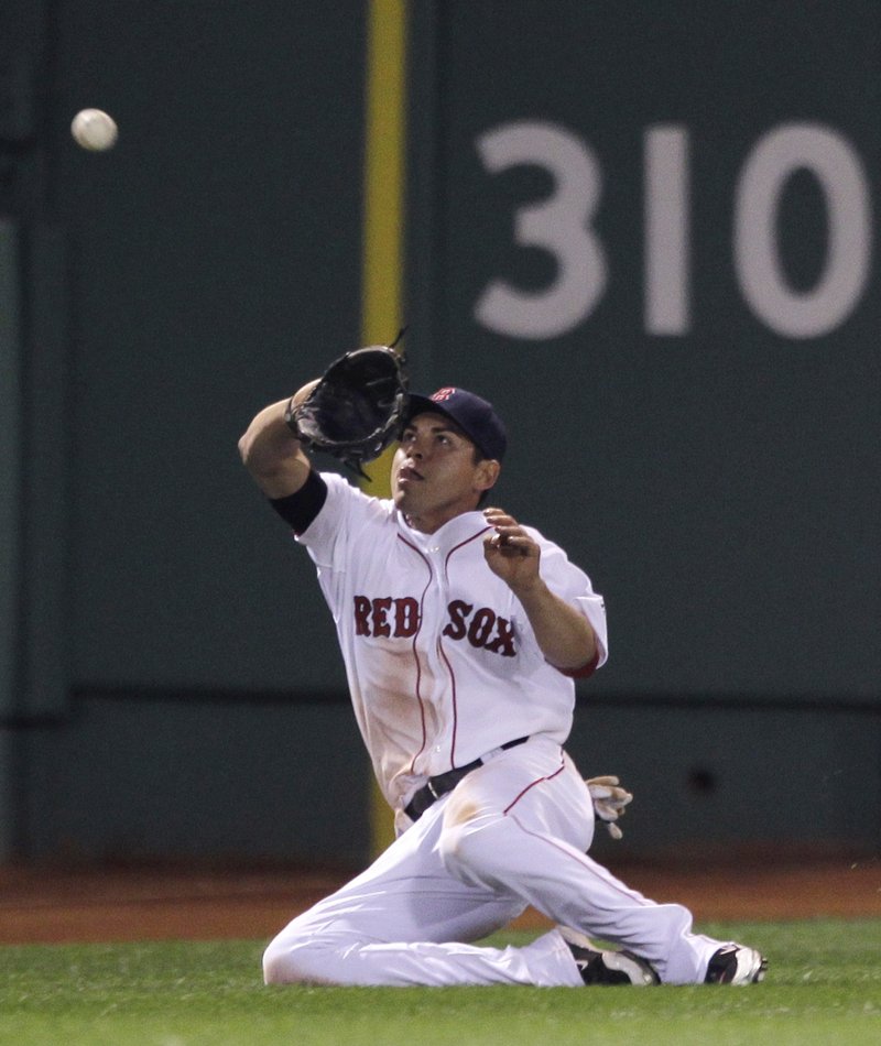 Jacoby Ellsbury of the Red Sox makes a sliding catch on a ball hit by Mark Teixeira of the New York Yankees in the seventh inning Tuesday night. The Yanks won, 6-4.
