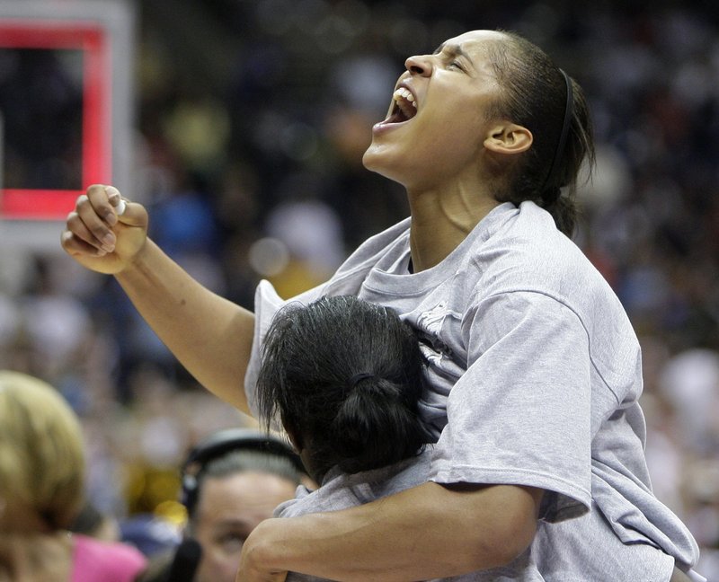 Connecticut's Maya Moore celebrates following the women's NCAA Final Four college basketball championship game against Stanford on Tuesday in San Antonio. Connecticut won 53-47.