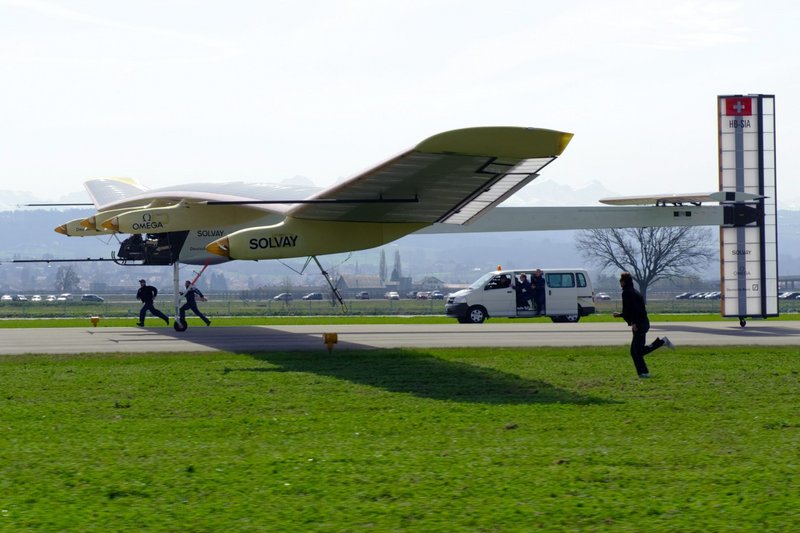 The solar powered aircraft "Solar Impulse," with test pilot Markus Scherdel, lands after its maiden flight at the military airport in Payerne, Switzerland, on Wednesday. The prototype, with the wingspan of a Boeing 747 and the weight of a small car, proved in a 90-minute test that it can keep a straight trajectory.