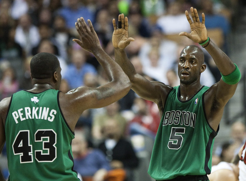 Kendrick Perkins, left, and Kevin Garnett of the Boston Celtics are all buddy-buddy Wednesday night, and why not? The Celtics beat the Toronto Raptors 115-104 and if you’re counting, that’s two straight years of sweeping the Raptors.