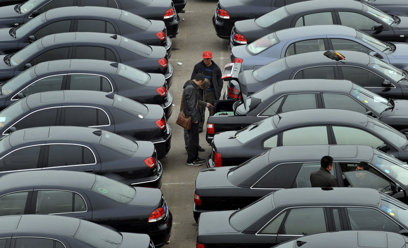 Customers trade used vehicles at an auto market in Shenyang, in northeast China. Passenger car sales in China soared in March.