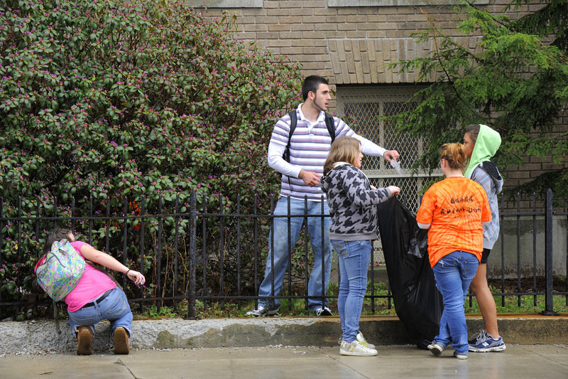 Middle-school kids enrolled in the Jobs for Maine's Graduates program pick up trash around Portland High School on Friday.