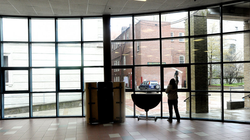 A middle-school student enrolled in the Jobs for Maine's Graduates program washes windows at Portland High Schoolon Friday. About 150 students from around the state participated in community service projects in the citu.