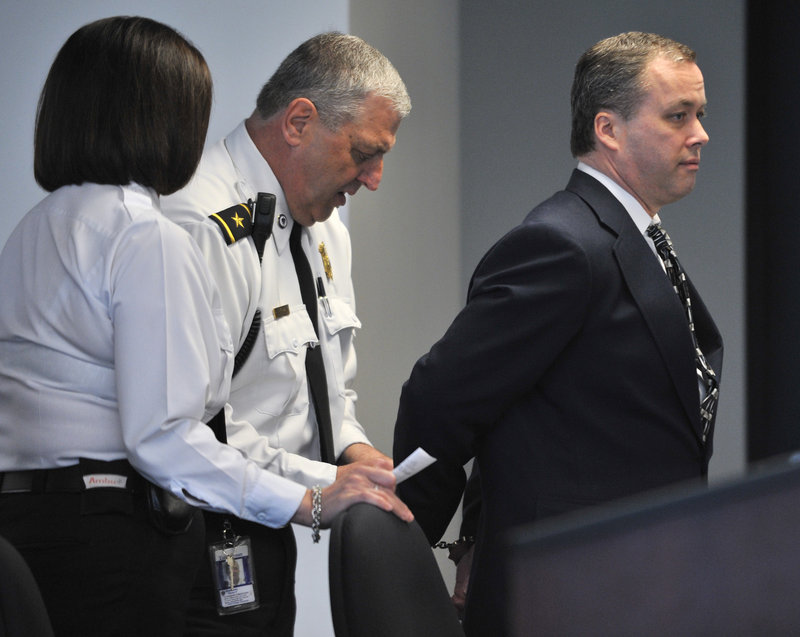 Officers handcuff Mark Kerrigan on Friday in Middlesex Superior Court in Woburn, Mass., pending the posting of additional bail after he pleaded not guilty to manslaughter in the January death of his 70-year-old father, Daniel Kerrigan.