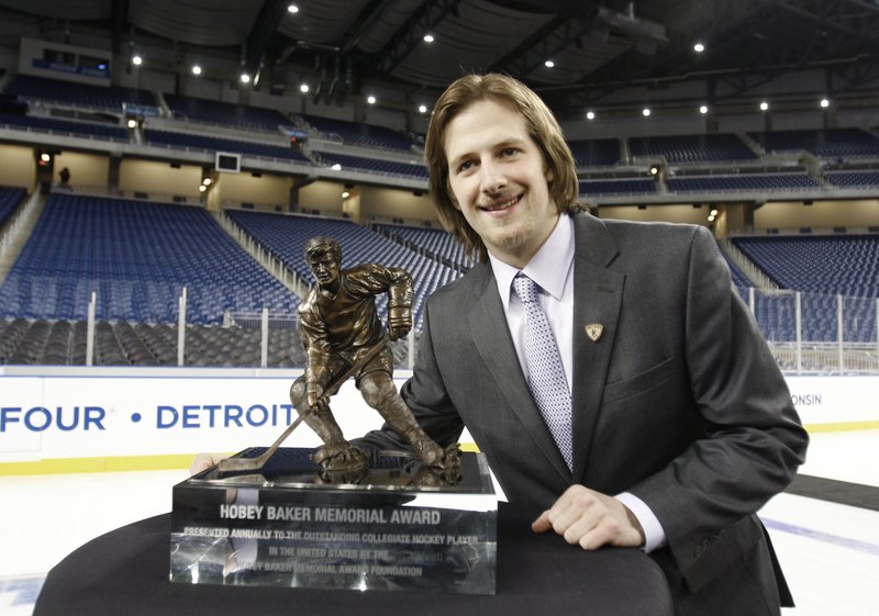 Blake Geoffrion poses with the Hobey Baker trophy after being named college hockey’s best player.