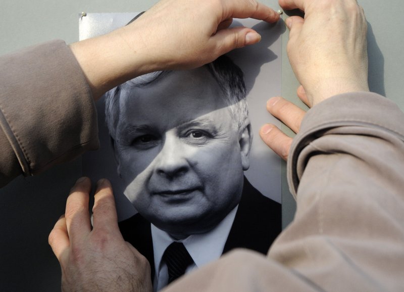 Polish Embassy employees place the portrait of President Lech Kaczynski near the embassy headquarters in Kiev, Ukraine, on Saturday.