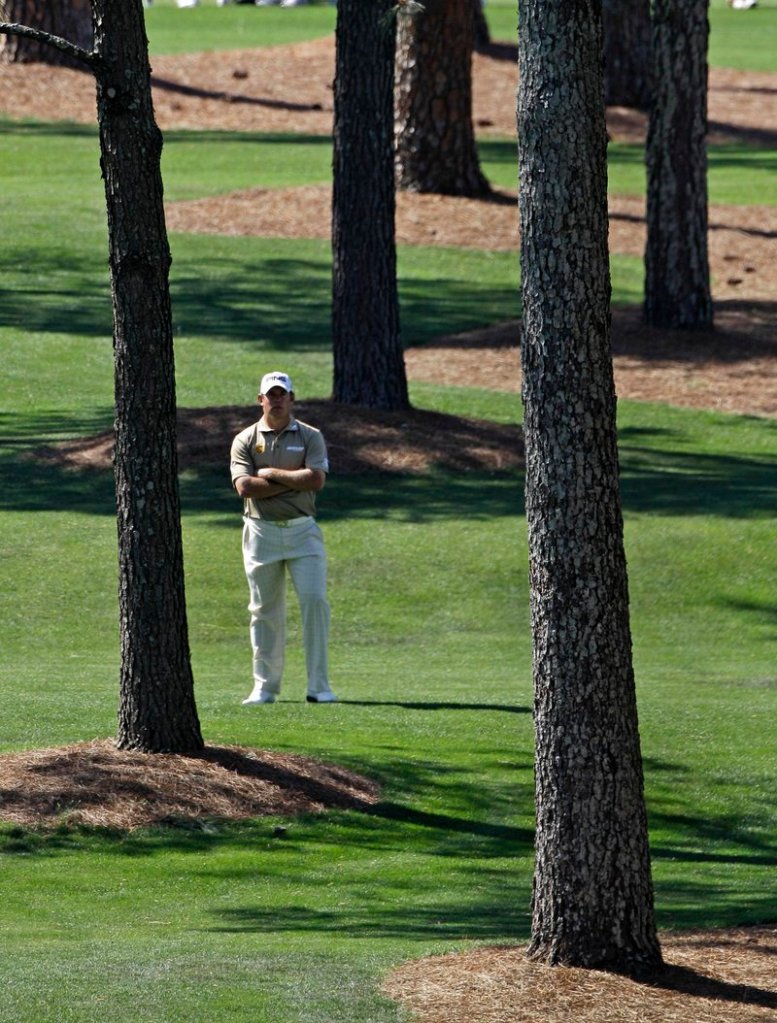 Lee Westwood surveys his options after a wayward drive on the seventh hole Saturday at the Masters. Westwood shot a 4-under 68 and was in the lead at 12 under.