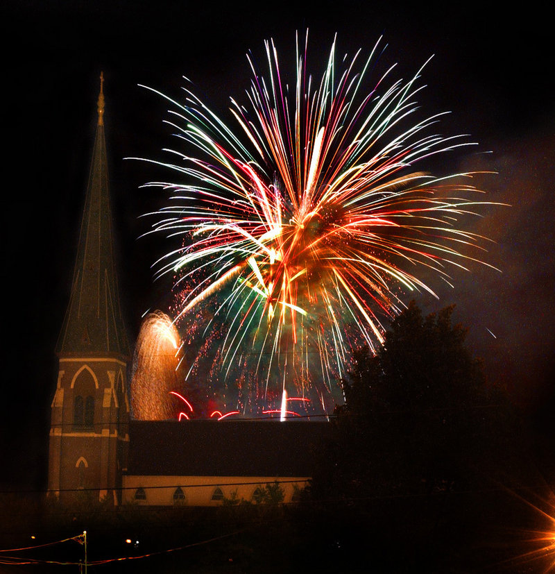 Fireworks blossom behind the Cathedral of the Immaculate Conception in Portland in 2002. Local business leaders have come forward to make sure the show goes on this year, after the display was cut from the citys proposed budget.