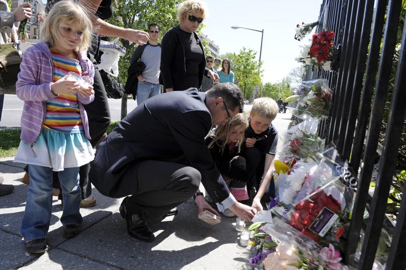 Mourners place lighted candles for President Lech Kaczynski and his wife, Maria, on Saturday at the gate of the Polish Embassy in Washington.