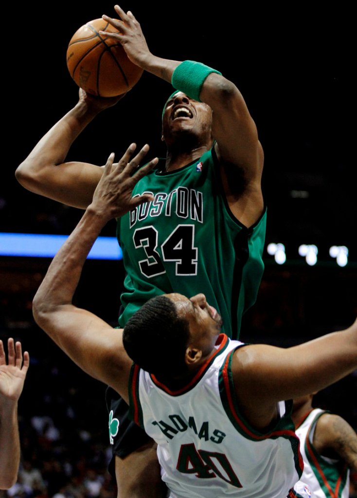Paul Pierce of the Boston Celtics is charged with an offensive foul Saturday night as Kurt Thomas of the Milwaukee Bucks absorbs the hit in the Celtics’ 105-90 victory.