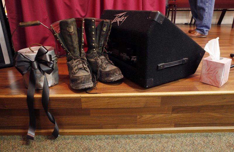Coal mining boots and a lunch pail sit near the altar at the church.