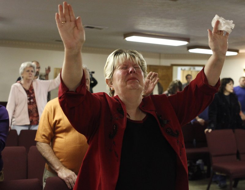 Judy Walker cries during a Sunday service at New Life Assembly church in Pettus, W.Va.