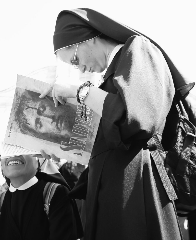 A nun reads a book about the Turin Shroud prior to a Mass on Saturday outside the cathedral in Turin, Italy, where the linen will be on display for the next six weeks starting next Saturday. The cloth is the object of centuries-old fascination.