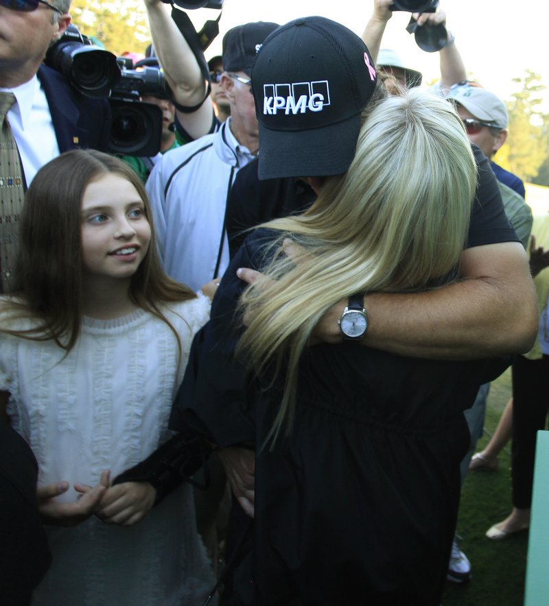 With daughter Amanda at his side, Mickelson shares a long embrace with wife Amy, who is undergoing treatment for breast cancer.