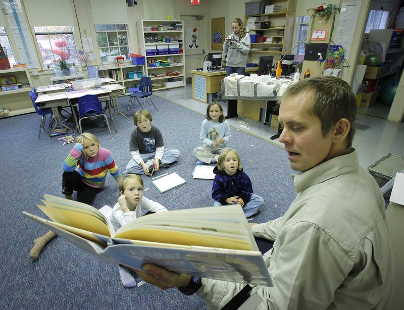 Teacher Josh Holloway reads a book to his students at Cliff Island School in this 2009 file photo. Giving young pupils a solid foundation can help teachers in higher grades do a better job, readers say.
