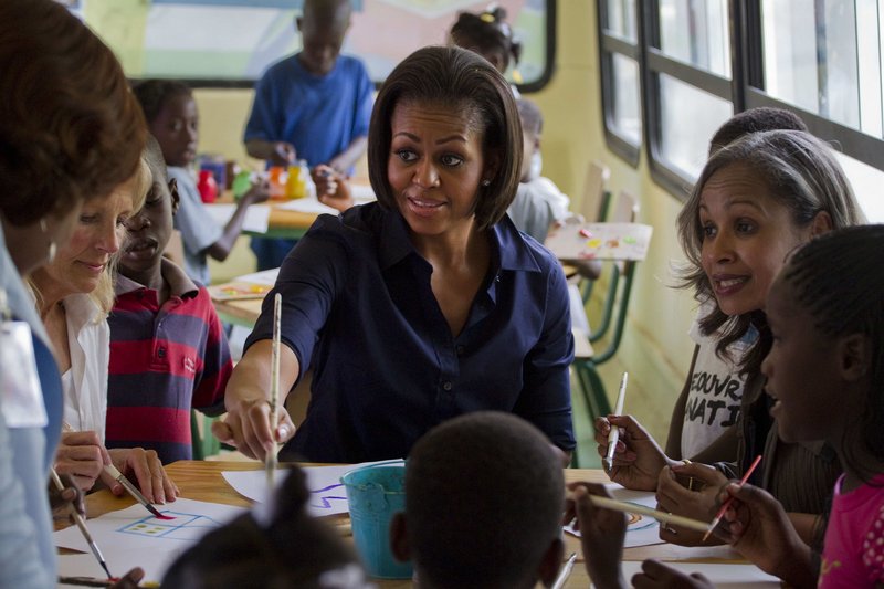 Michelle Obama paints Tuesday at a center for displaced children in Port-au-Prince. The visit was intended to underscore the U.S. commitment to reconstruction after the January earthquake.