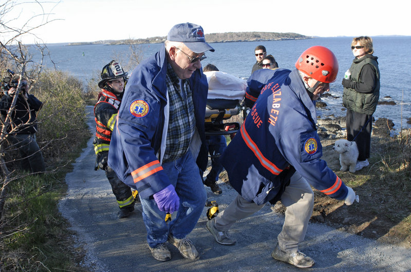 Cape Elizabeth Rescue personnel carry a man up a trail at Fort Williams Park after he had fallen from a cliff along the Cape Elizabeth shoreline Tuesday.