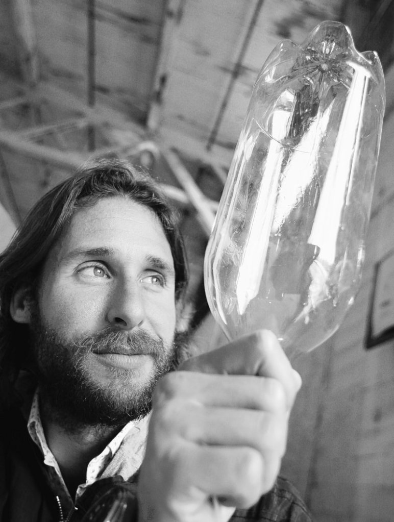 British environmentalist David de Rothschild holds a plastic soda bottle, 12,000 of which comprise the vessel “Plastiki.” The voyage is part of an effort to raise awareness of the recycling of plastic bottles, which de Rothschild says are a symbol of global waste.