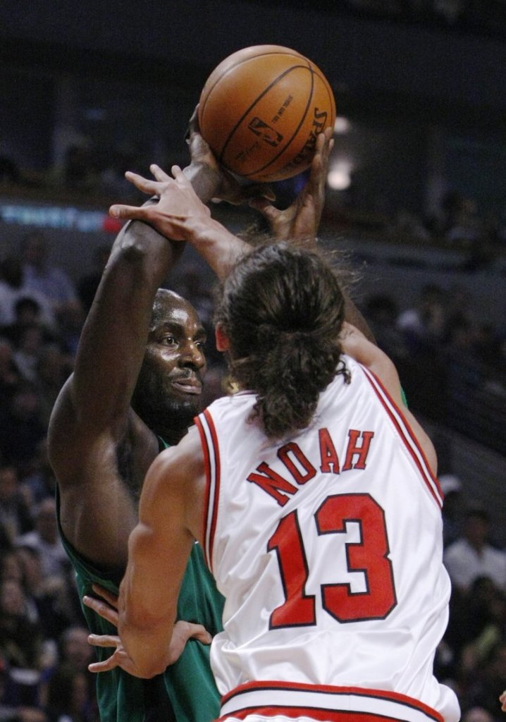 Joakim Noah of the Chicago Bulls pressures Kevin Garnett of the Boston Celtics during the first half of their game Tuesday night. The Bulls earned a 101-93 victory.