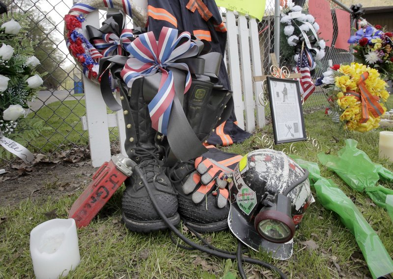 A miner’s boots, helmet and gloves appear in a memorial in Whitesville, W.Va., on Tuesday, for the miners who died in an explosion at the Upper Big Branch mine in Montcoal, W.Va., a week ago Monday. Teams early Tuesday finished recovering the last of 29 miners killed in the disaster.