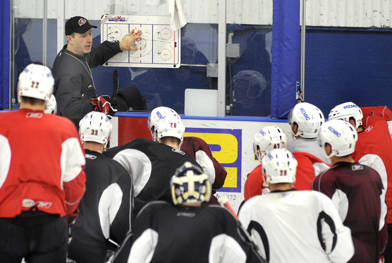 Coach Kevin Dineen goes over plays during the Pirates' practice Wednesday. Portland opens a best-of-seven playoff series against Manchester on Friday at the Civic Center.
