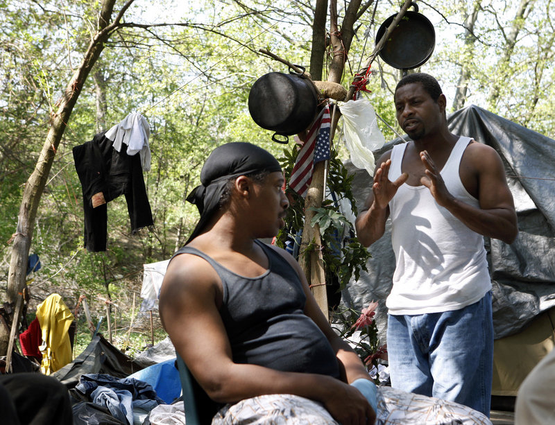 Gino Ortis, left, and fellow Tent City resident Marvin Tomlinson discuss the possibility of leaving the Camden, N.J., camp. Today is the deadline set by the county Board of Social Services to close down the self-governing society of homeless people that’s sprung up on a tract of public land.
