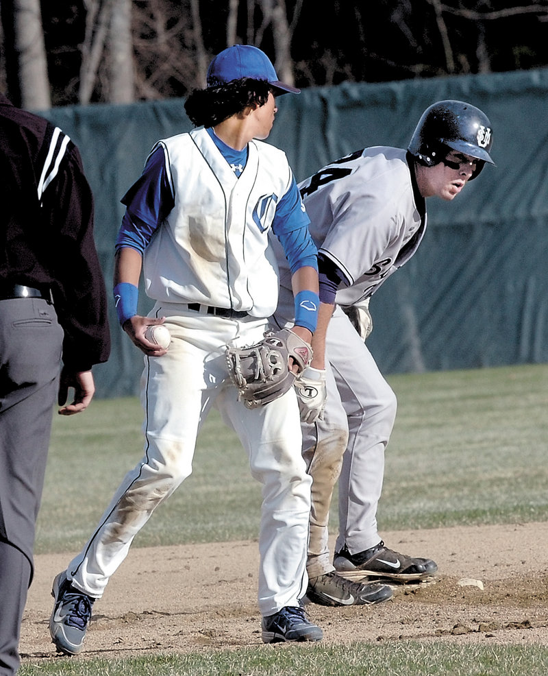 Colby shortstop Brandon Nieuw checks USM base runner Mike Eaton, who reached second base during Wednesday's game at Waterville. The Huskies rallied in the ninth inning for an 11-7 victory.