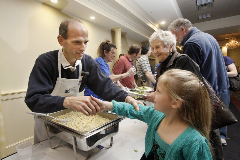 Kai Myers, 6, of Portland shakes hands with Gov. John Baldacci at the Italian Heritage Center in Portland, where he hosted a spaghetti supper to benefit Preble Street.