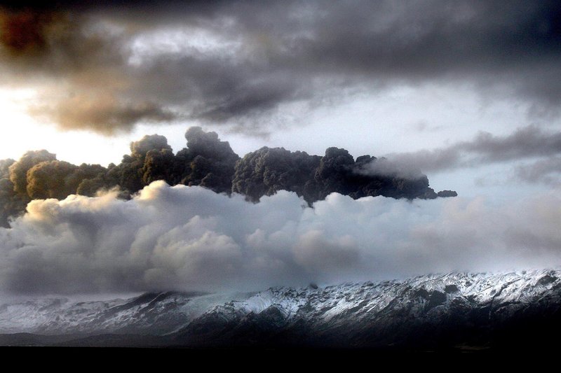 Smoke and steam hang over the volcano erupting under a glacier in Iceland. Ash drifting across the Atlantic disrupted air traffic across northern Europe on Thursday, stranding thousands of passengers.
