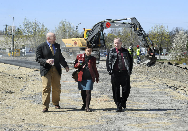 Jim Gooch, Nan Cumming and Mark McAuliffe explore the construction in progress for the trail. Some critics say the greenway concept is not an efficient use of the urban grid, but supporters say open space and a pedestrian infrastructure are important features.