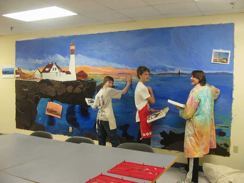 Cape Elizabeth Middle School students, from left, Josh Grassele, Trevor Gale and Austin Andrew work to complete a mural of Portland Head Light before Arts Night.