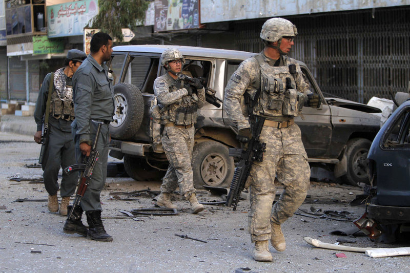 U.S. soldiers arrive at the scene after a car bomb exploded outside a hotel in the southern Afghan city of Kandahar on Thursday. At least a half-dozen people were injured in the blast. Readers wonder why the United States is still involved in this war.