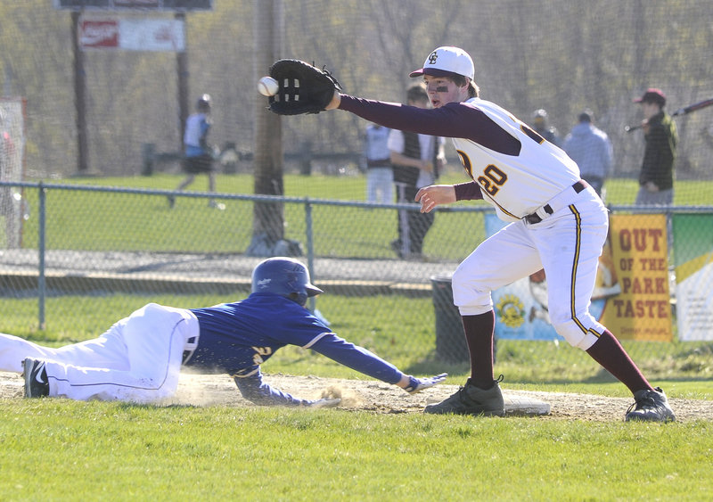 Falmouth’s Dillon Dresser dives back safely to first base as Will Pierce of Cape Elizabeth fields the pickoff attempt Thursday. Cape won, 4-2.