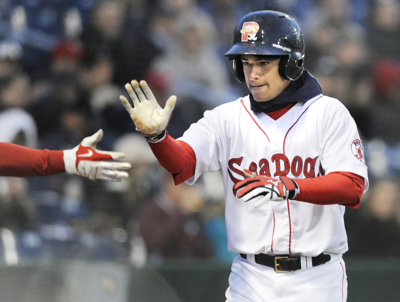 Jose Iglesias of the Portland Sea Dogs is greeted Thursday night after scoring in the fifth inning against the Trenton Thunder in the home opener at Hadlock Field. Iglesias doubled – the first Portland hit of the game – and scored on Jason Place's single.