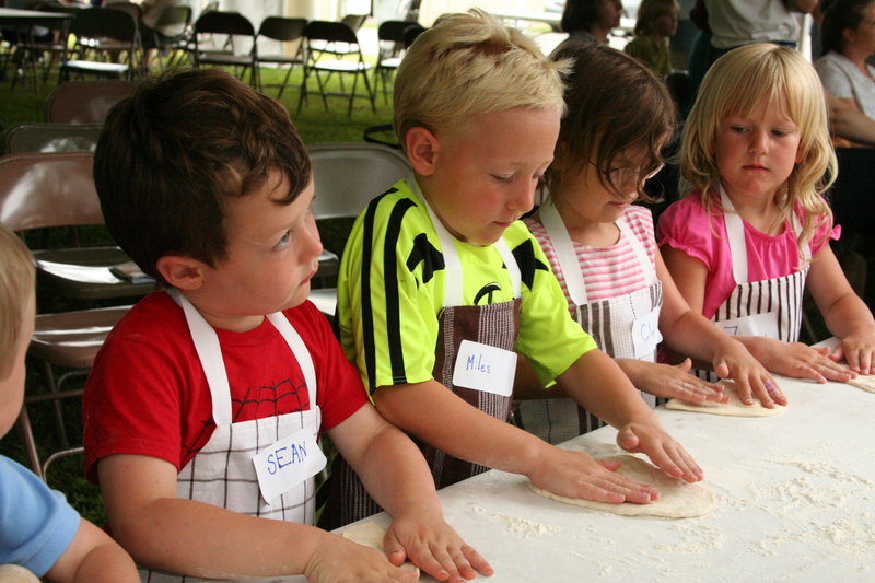 Children prepare dough for pizza at a workshop during last year's Artisan Bread Fair following the Kneading Conference in Skowhegan. This year's event, July 29-31, has been moved to the Skowhegan Fairgrounds to accommodate more participants.