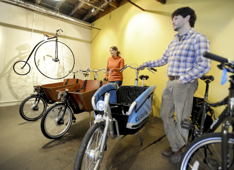 Gillian Kitchings and Josh Cridler own and operate Portland Velocipede, a bicycle shop recently opened in Portland. The new owners are seen with Dutch box bikes, that allow riders to carry lots of items, like groceries, and also give a comfortable ride.
