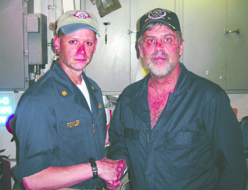 Capt. Richard Phillips, right, shakes hands with Lt. Cmdr. David Fowler of the USS Bainbridge after Phillips was rescued by U.S. Navy SEALs off the coast of Somalia.